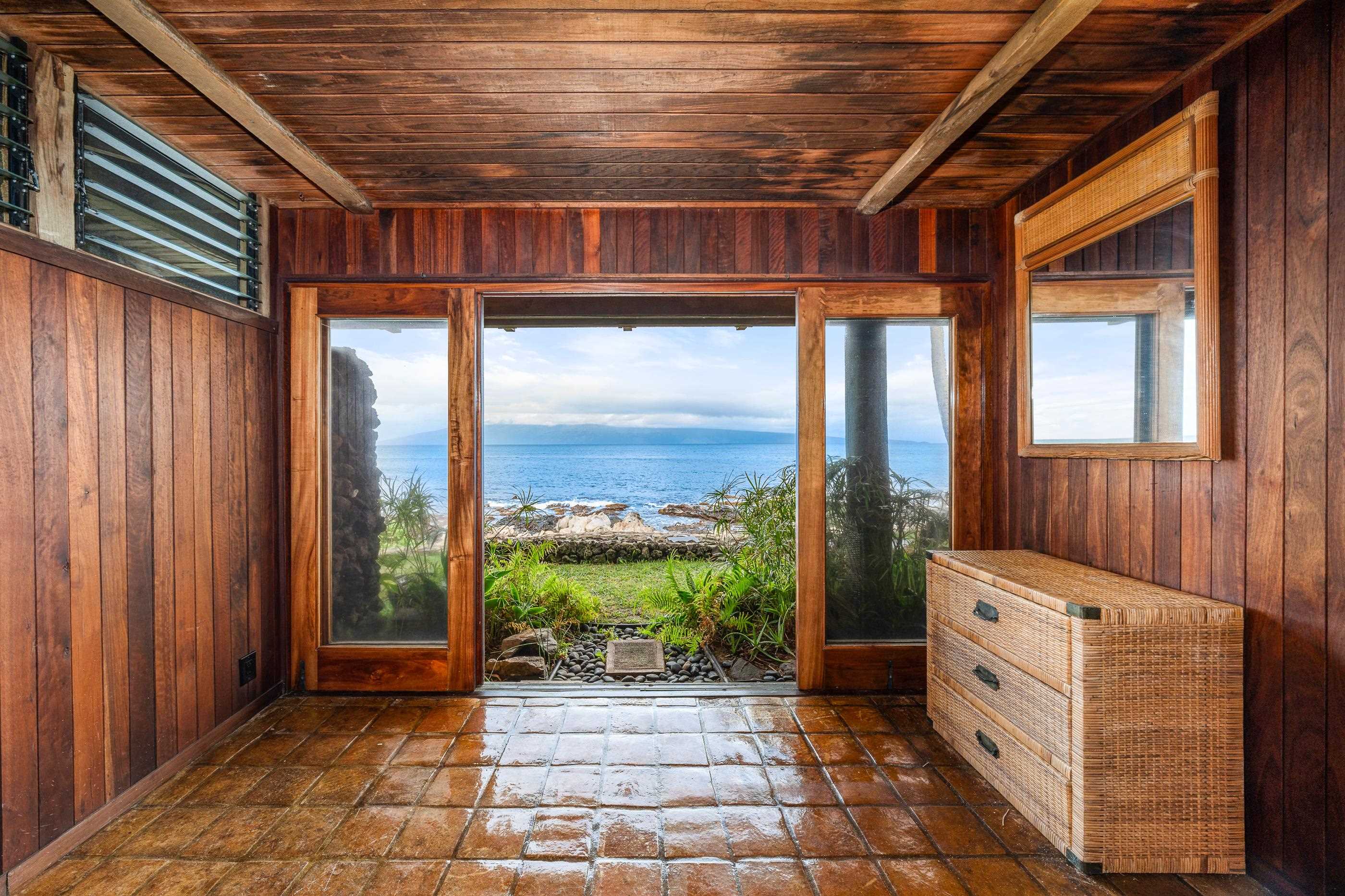Garden room with glass doors straight onto the lawn and the water beyond